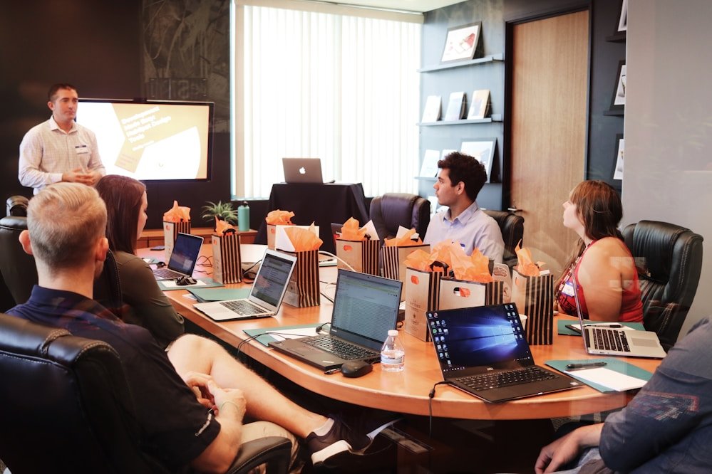 Team meeting around laptops in a collaborative space